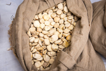 Beans in sack legumes. Beans grains on a rustic cloth bag. Agriculture and harvest.