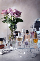 Stand with bottles of perfume on table