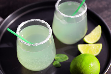 Tray with delicious margarita cocktails on table