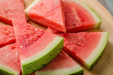 Slices of watermelon on a wood cutting board