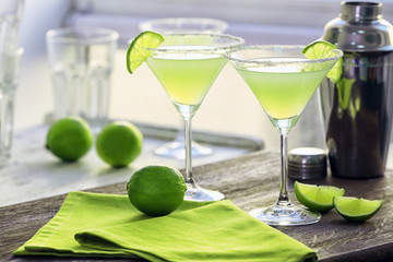 Delicious margarita cocktails on table
