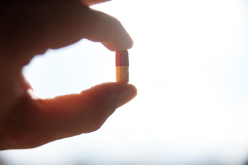 Pills in a hand on a white background.