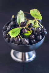 Fresh picked aronia in the metal bowl,selective focus