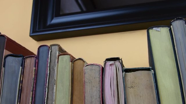 Vintage books. View of row of old books and vintage typewriter