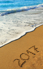 Number 2017 written on seashore sand 