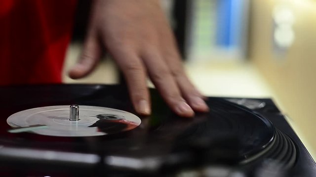hand DJ scratching on the Turntables