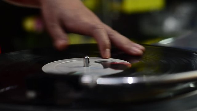 hand DJ scratching on the Turntables
