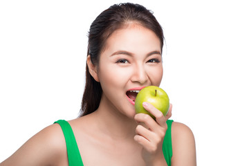 Young beautiful asian woman eating fresh green apple on white background