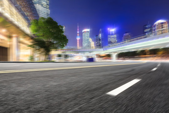 Motion blur asphalt road and modern buildings in Shanghai