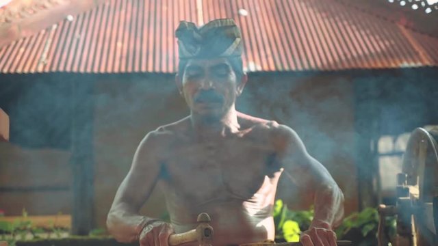 Balinese iron smith making tools traditional way in village, tilt up