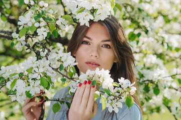 Woman near blooming apple tree