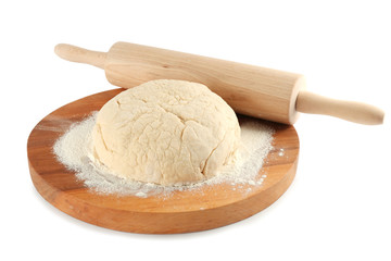 Cutting board with ball of raw dough and rolling pin on white background