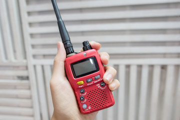 A hand holding red Walkie-Talkie