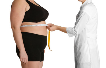 Doctor measuring stout adult woman on white background. Weight loss concept