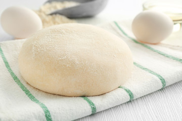 Ball of raw dough and ingredients on table