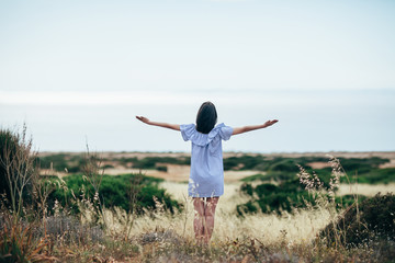 Happy woman enjoy beautiful valley and sea landscape