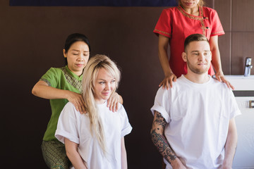 Fototapeta premium Peaceful couple enjoying couples massage poolside outside at the spa