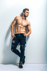 Naklejka premium Full length portrait of a sexy muscular shirtless man