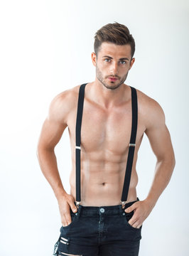 Sexy muscular shirtless man in suspenders