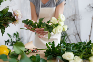 Young florist woman with flowers