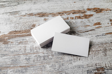 Blank white business cards on vintage wooden background. Mock-up for branding identity. Blank template for design presentations and portfolios.
