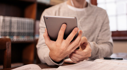 College student using tablet pc in library