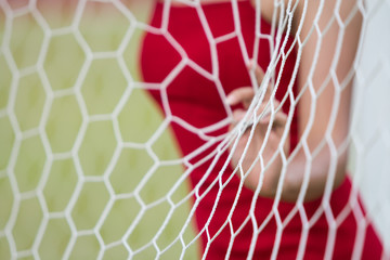 The girl behide the Goal Nets.Select focus.