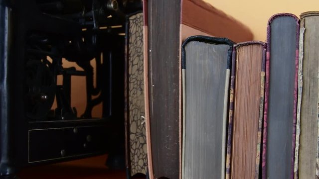 Vintage books. View of row of old books and vintage typewriter