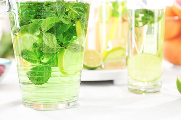 Glassware with refreshing lemonade on table