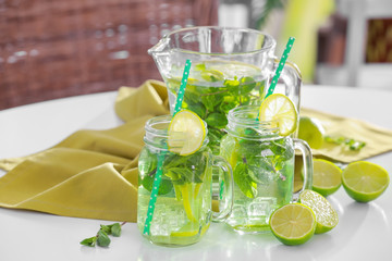 Glassware with refreshing lemonade on table outdoor