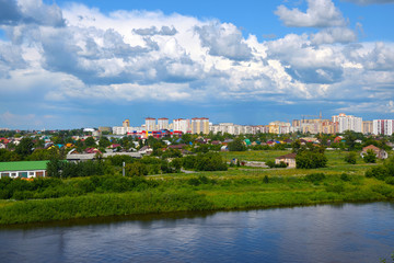 Construction of a new microdistrict in the Siberian city against the backdrop of the river and ship..