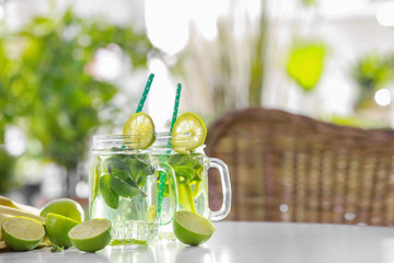 Glassware with refreshing lemonade on table outdoor