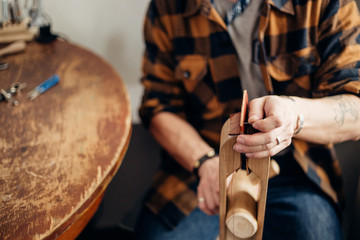 Professional crafter making leather items