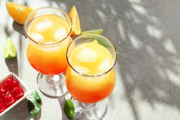 Glasses of delicious tequila sunrise cocktails on table