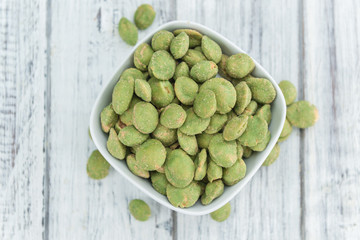 Peanuts (with Wasabi flavor) on vintage wooden background