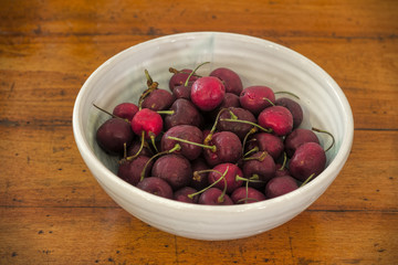 Bowl of Cherries on Wooden Table