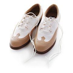 Pair of female golf shoes on white background
