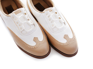 Pair of female golf shoes on white background