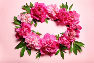 Frame made of beautiful peonies on light color background