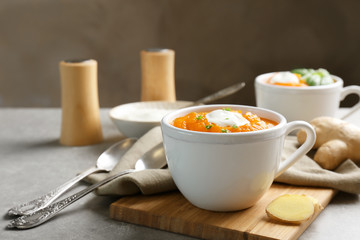 Delicious carrot soup on table
