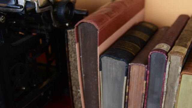 Vintage books. View of row of old books and vintage typewriter