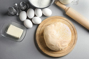 Raw dough with ingredients on kitchen table. Cooking classes concept