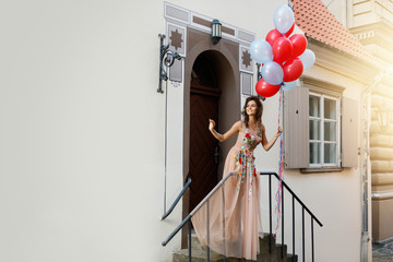Woman in beautiful dress with a lot of colorful balloons © blackday