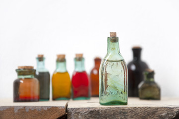 Mock up of small glass antique bottle with liquids. Selective focus. For the pharmacy, oil, cosmetics.