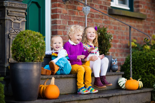 Kids at house porch on autumn day