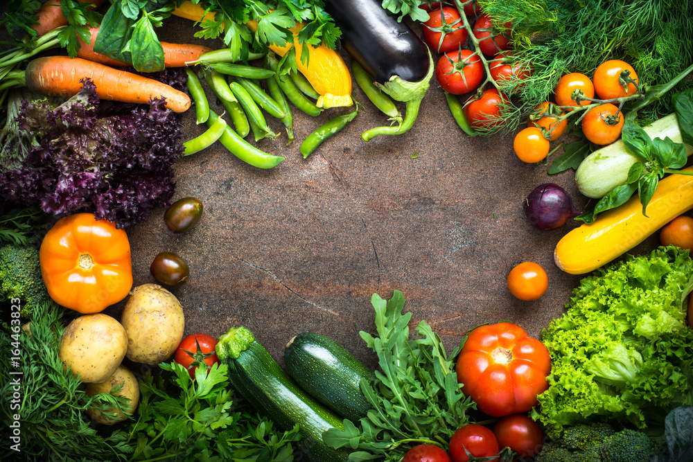 Wall mural Organic farmer vegetables on dark slate table.