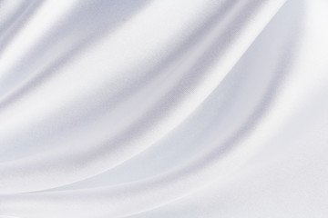 Fototapeta na wymiar white satin fabric with large folds, soft abstract background