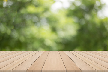 Wood table top on nature green blurred background,for montage your products