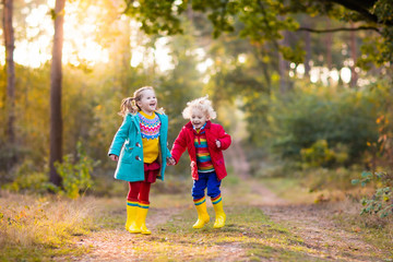 Kids play in autumn park. Children in fall.