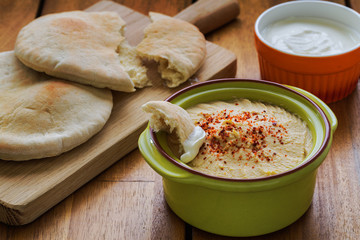 Homemade hummus yogurt dip on wood table